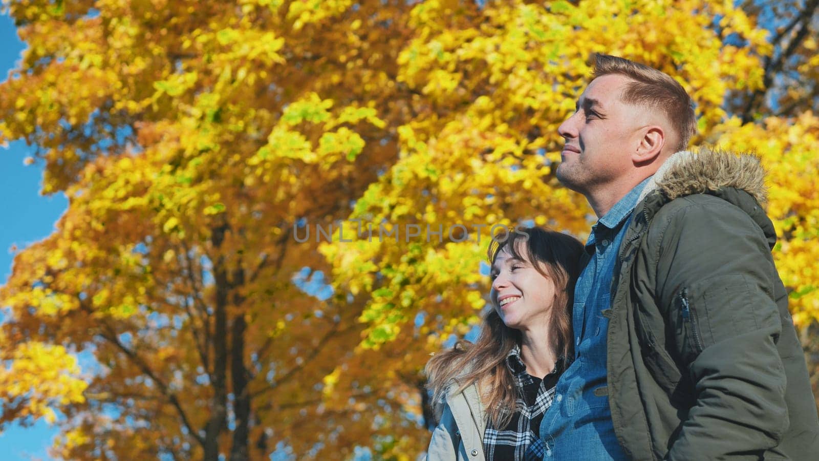 Happy and in love young couple in the park in the fall