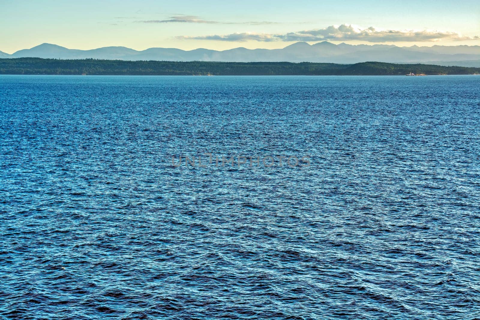 Coastal Mountains view from a ship on Pacific ocean.