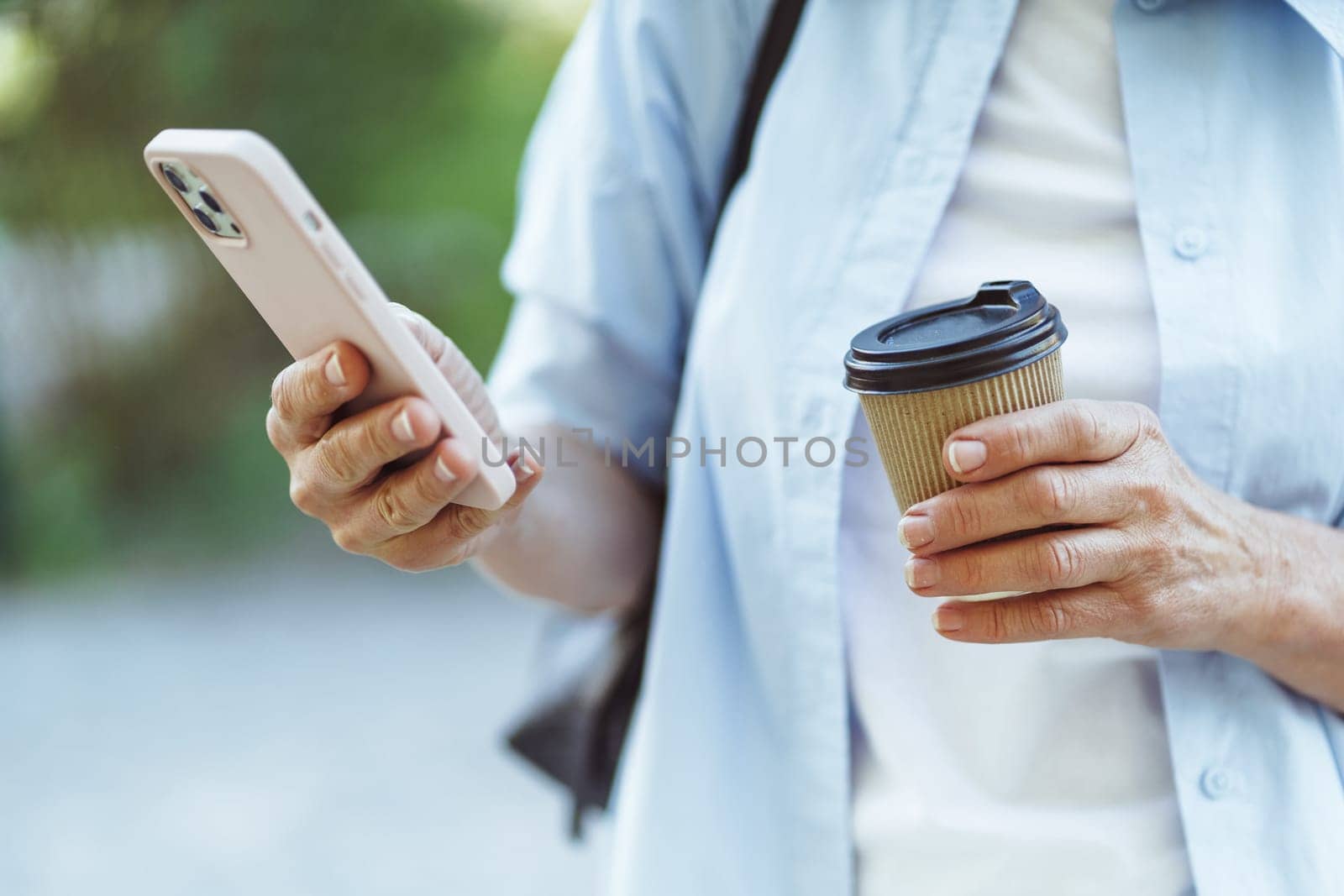 Cup of coffee alongside smartphone, symbolizing combination of digital communication and pleasure of coffee consumption. Coffee and mobile communication on internet concept. by LipikStockMedia