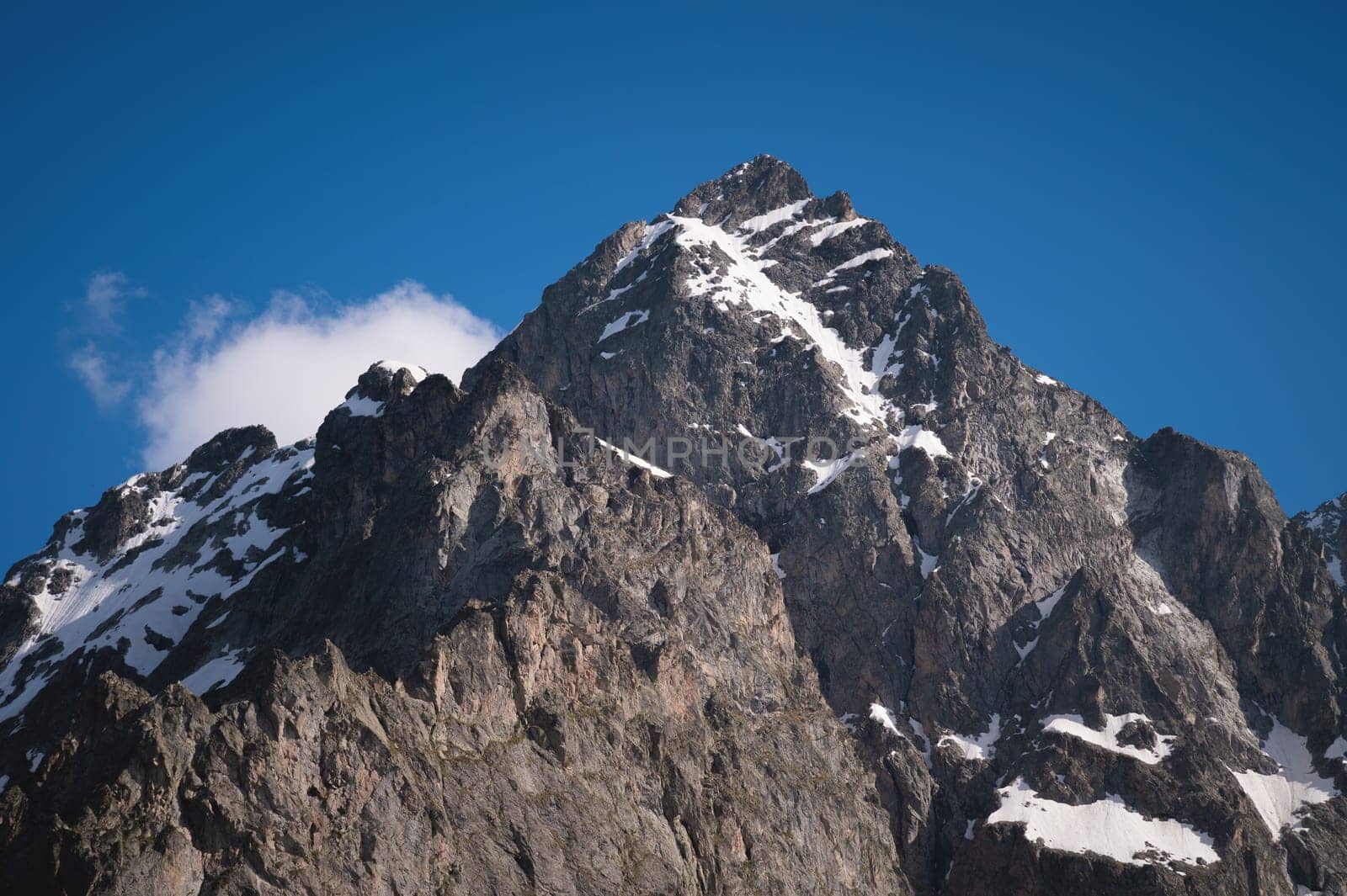 View of the Himalayan peaks. Close-up of a secluded mountain peak with snow on a sunny clear day.