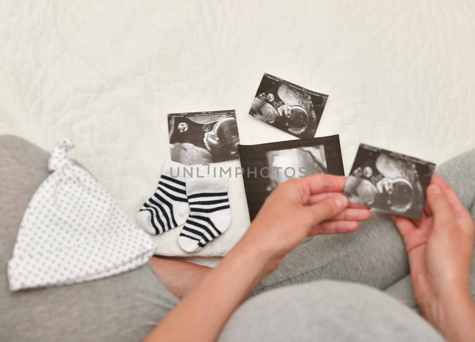 Pregnant woman holding ultrasound image