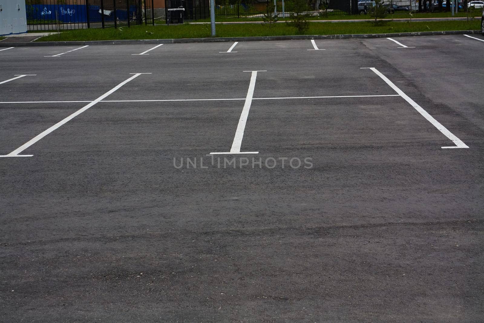 Photo of empty parking lot without cars. by electrovenik