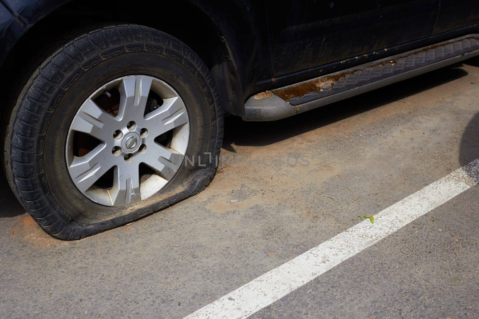 Photo of flat tire of car, torn tire. Road, traffic, vehicle. Machine breakdown.