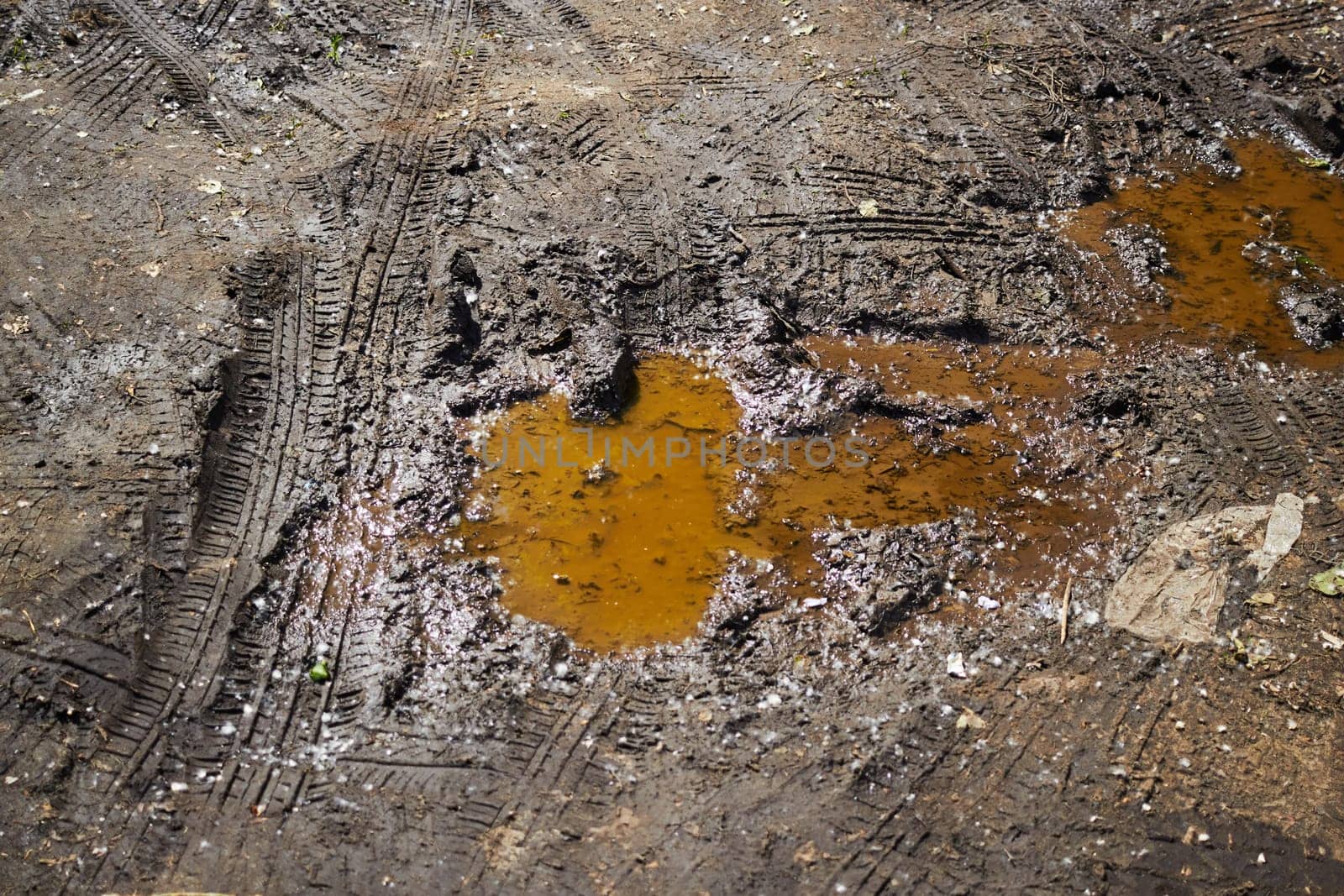 Photo after rain puddle and dirt from tire tread. Off-road. Rainy weather.