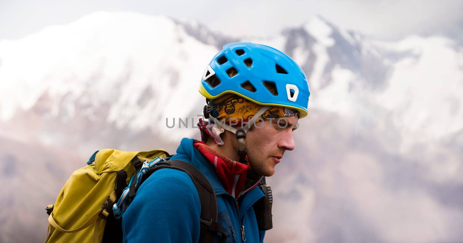 Portrait of a climbing man in a helmet. by africapink