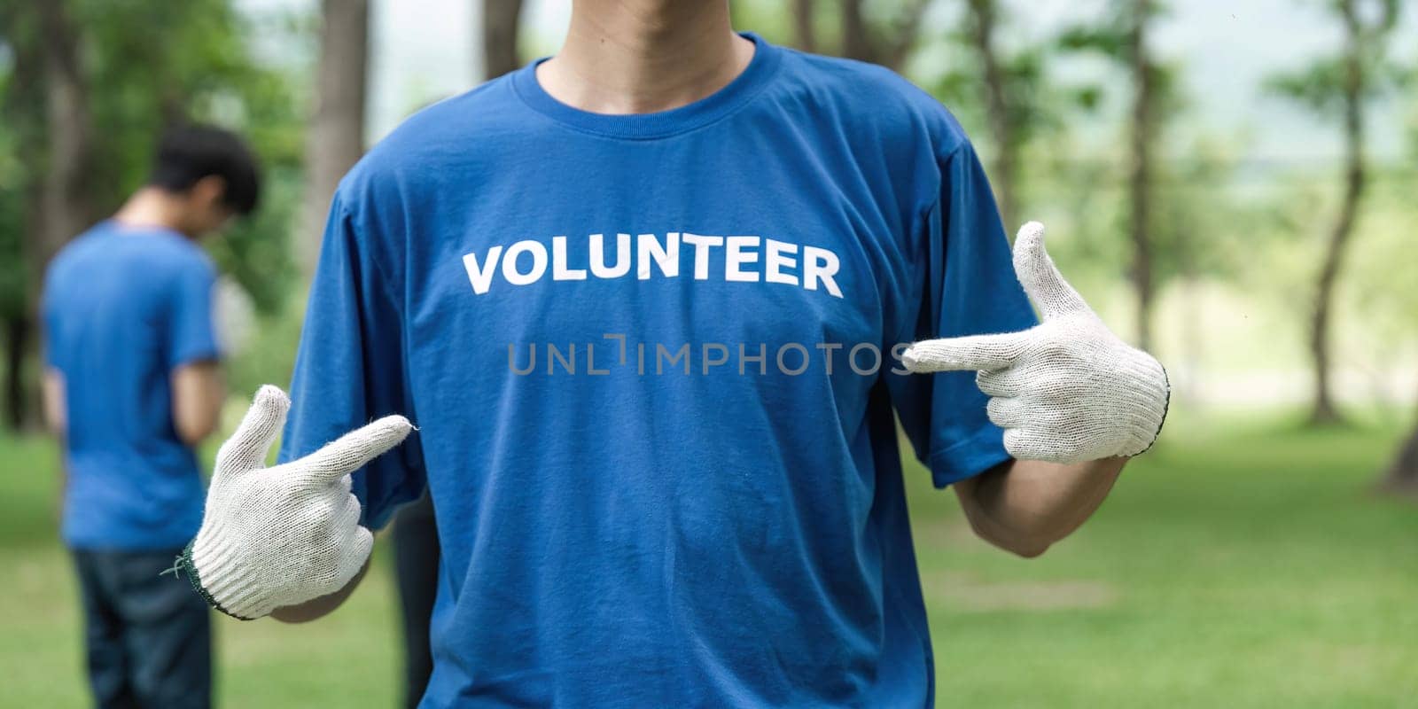 Close up young man volunteering wearing t-shirt with volunteer message.