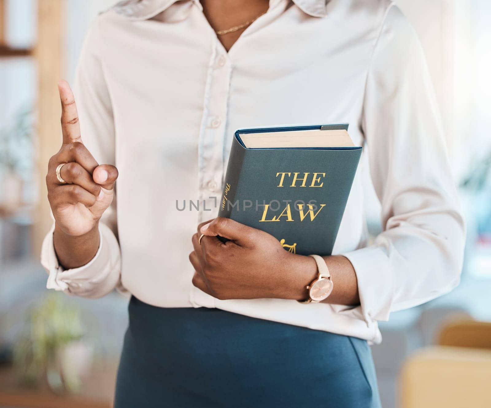 Legal, lawyer and book with hands of black woman in office for advocate, justice and consultant. Attorney, advisor and study with closeup of person in law firm for knowledge, expert and government by YuriArcurs