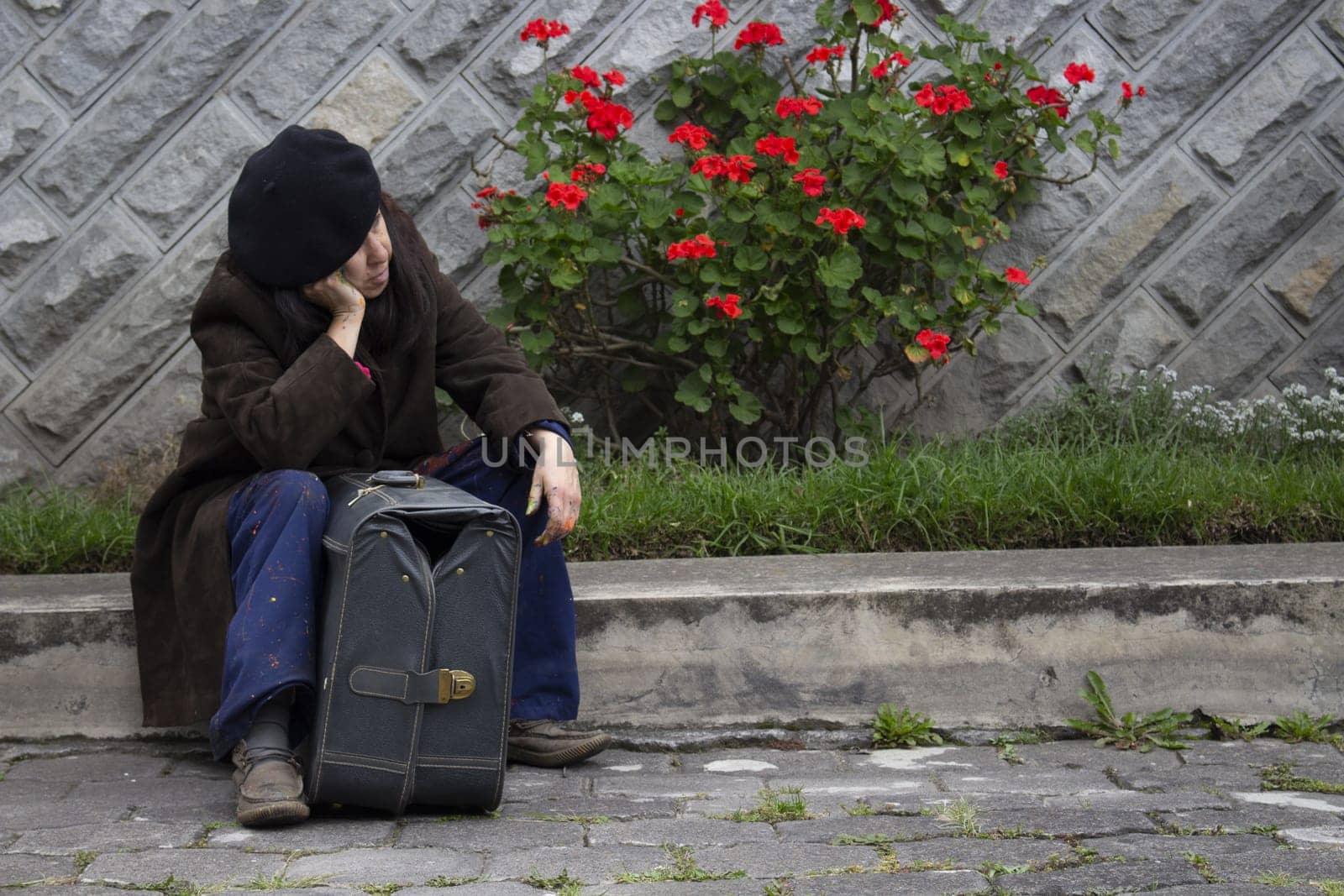 copyspace of old unhappy alzheimer patient with suffering and depression abandoned in the street next to an old gray suitcase. High quality photo