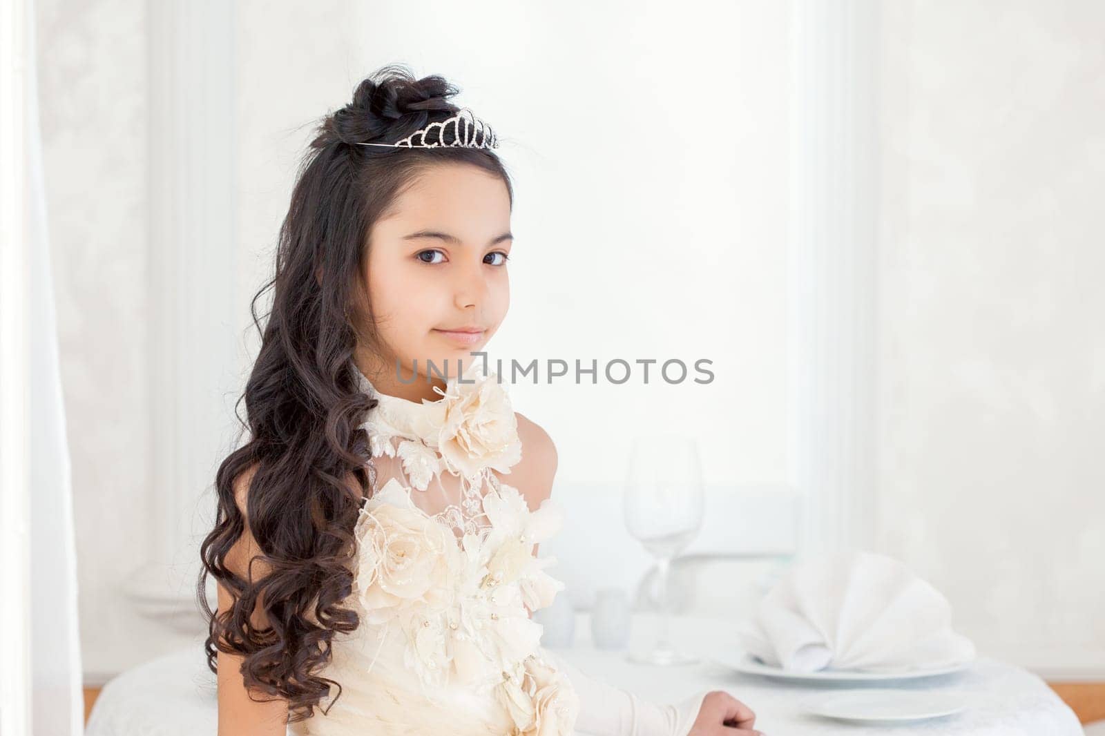 Pretty long-haired brunette posing in tiara, close-up