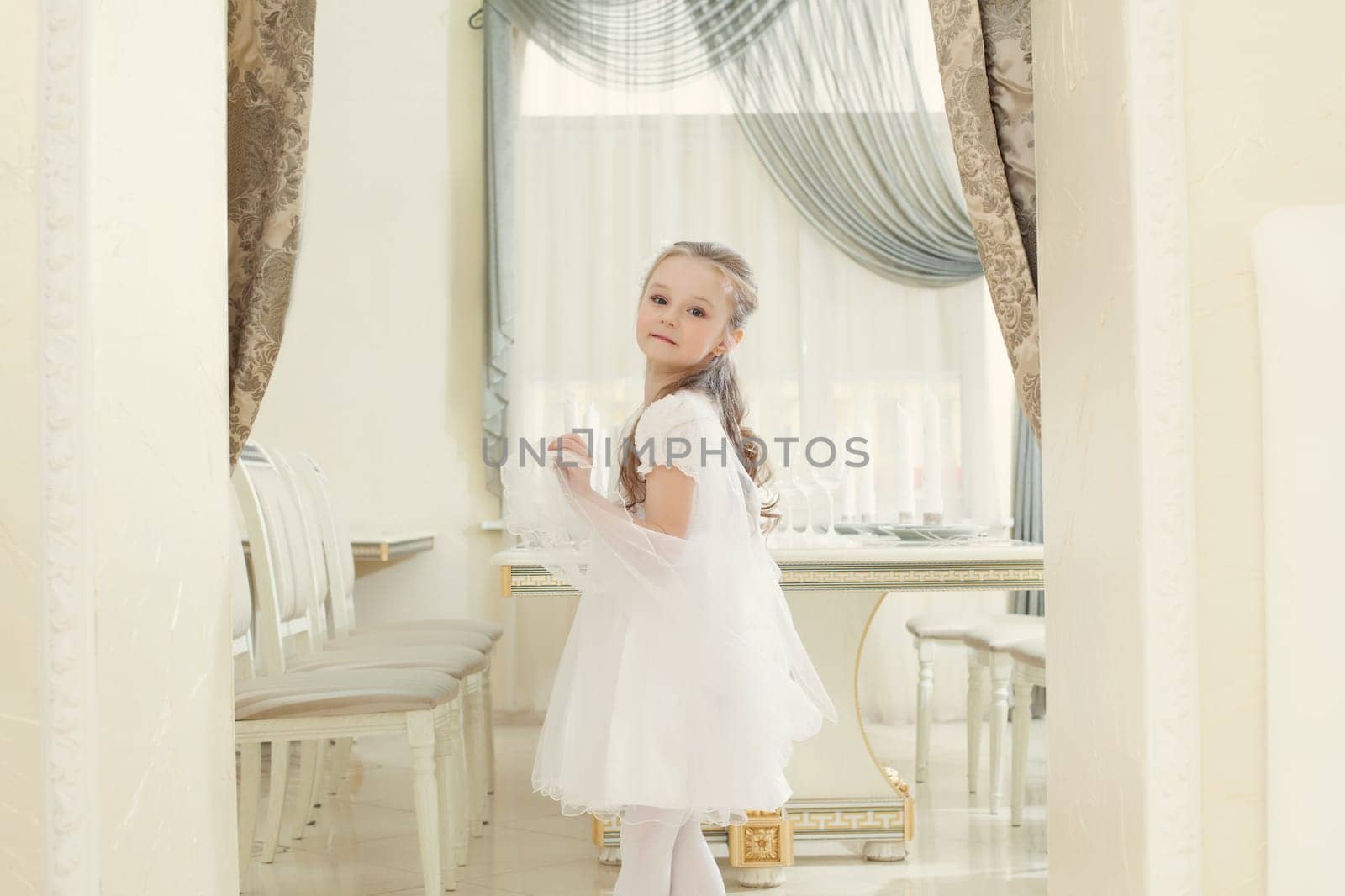 Image of adorable little girl posing in restaurant