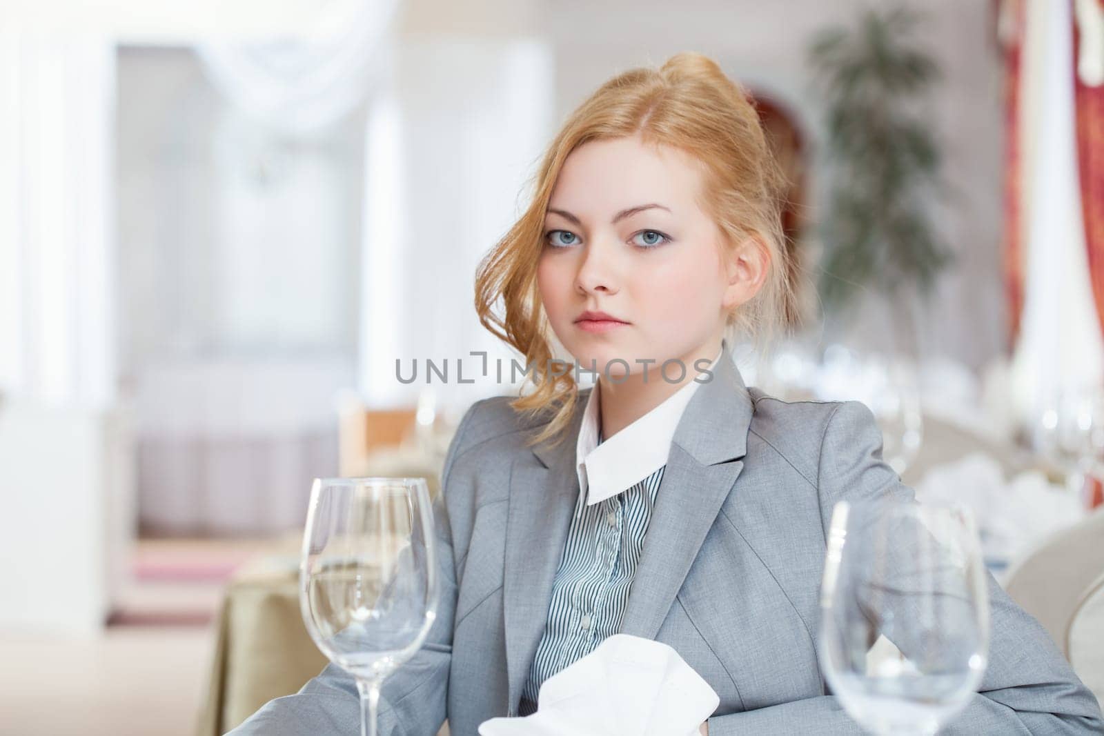 Serious business woman posing in restaurant, close-up