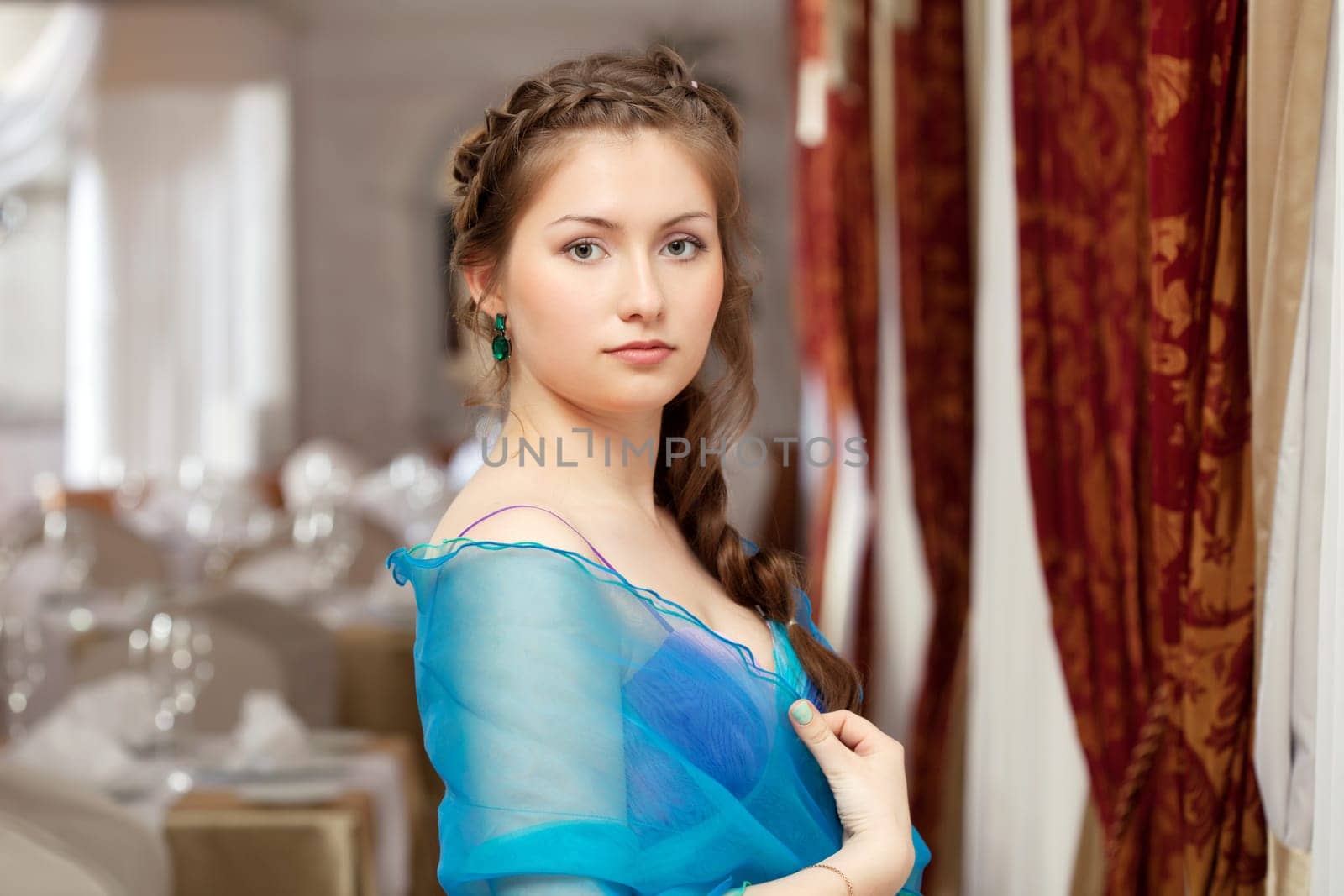 Image of elegant young girl posing in restaurant