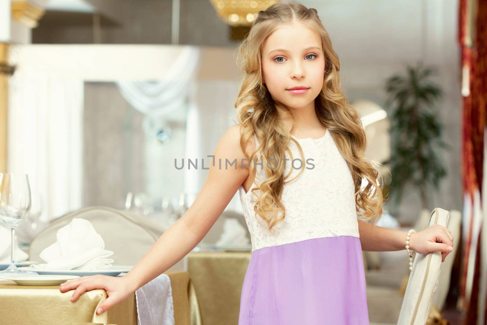 Image of charming long-haired girl posing in restaurant