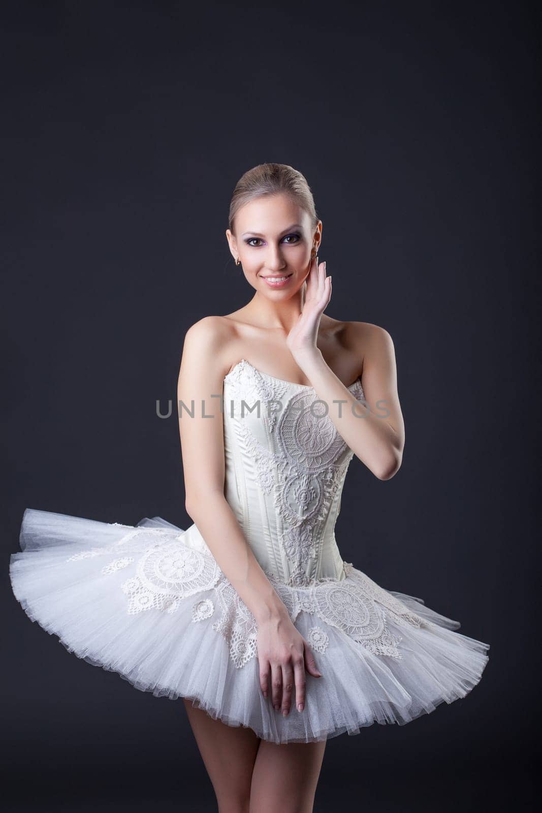 Young charming ballerina posing smiling at camera, close-up