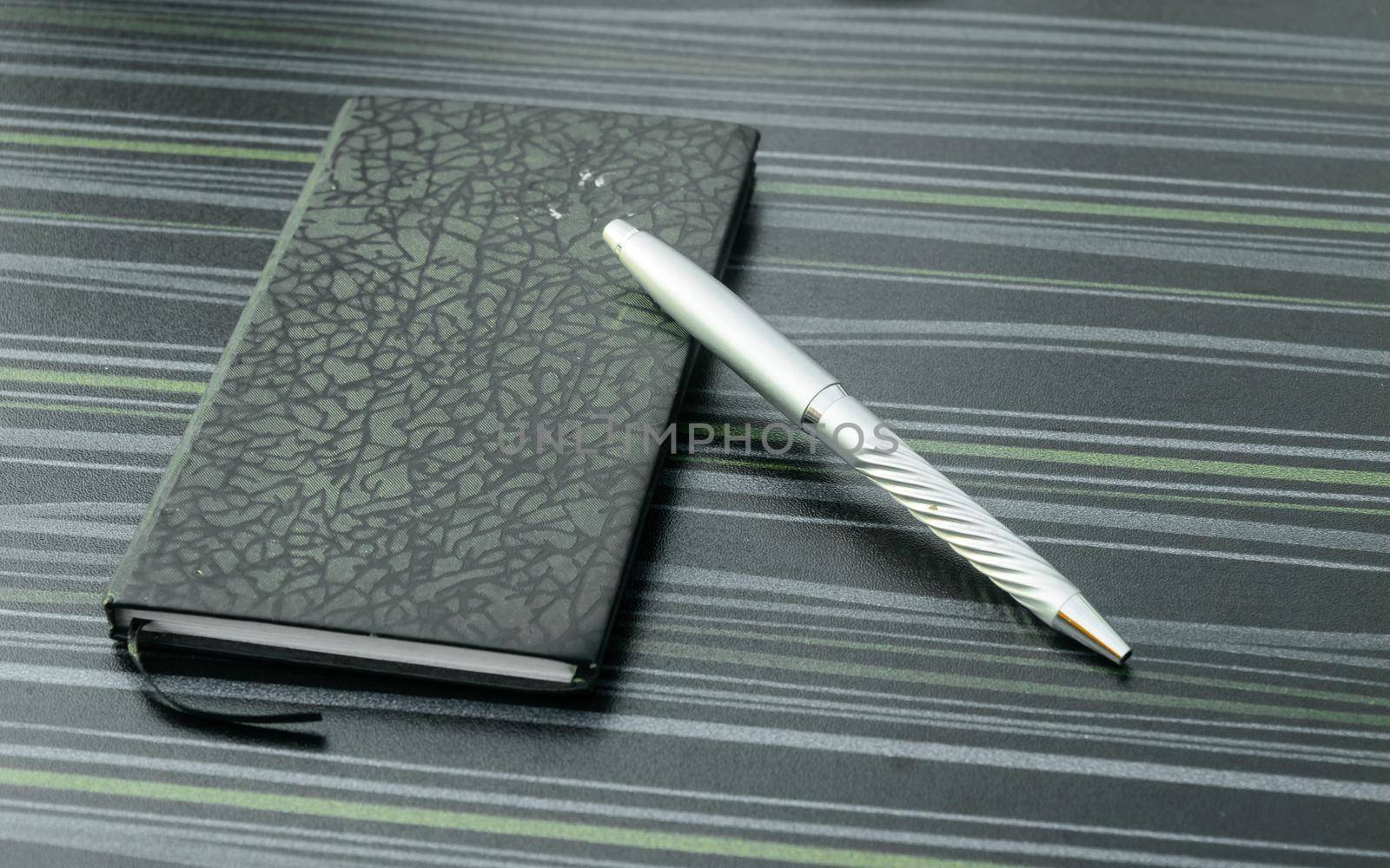 Pen and notebook on office table. Table top view. Corporate business background. by sudiptabhowmick