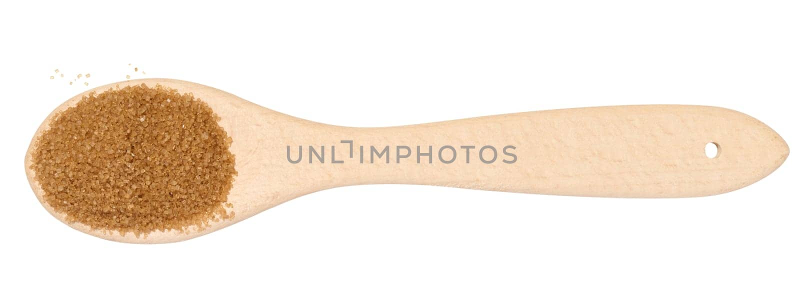 Wooden spoon with brown cane sugar on a white background, top view