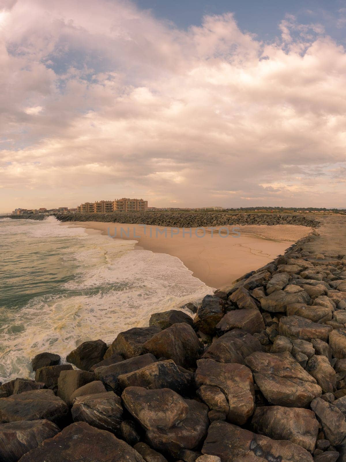 View south of Furadouro beach in Ovar on a stormy day at sunset.