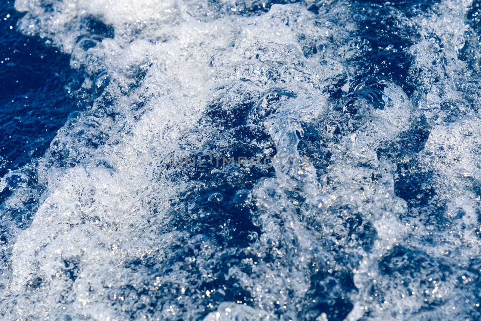 Abstract blue sea water with white waves. Blue sea texture with waves and foam. Mediterranean sea by PhotoTime