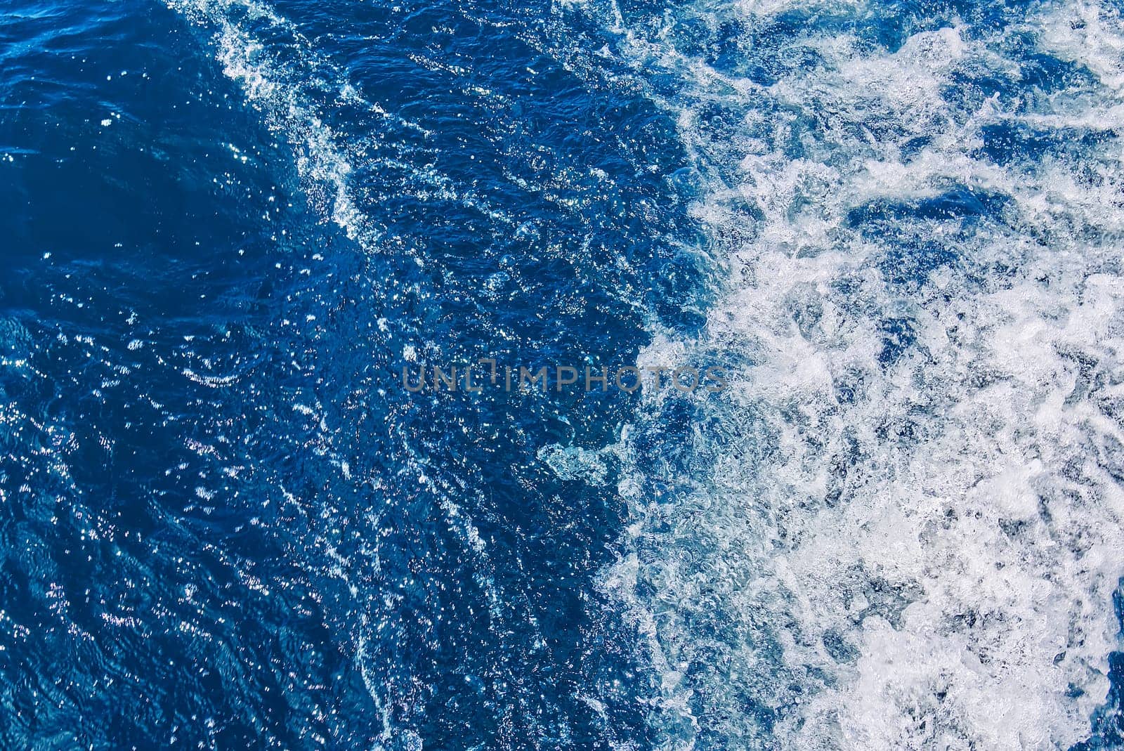 Abstract blue sea water with white waves. Blue sea texture with waves and foam. Mediterranean sea by PhotoTime