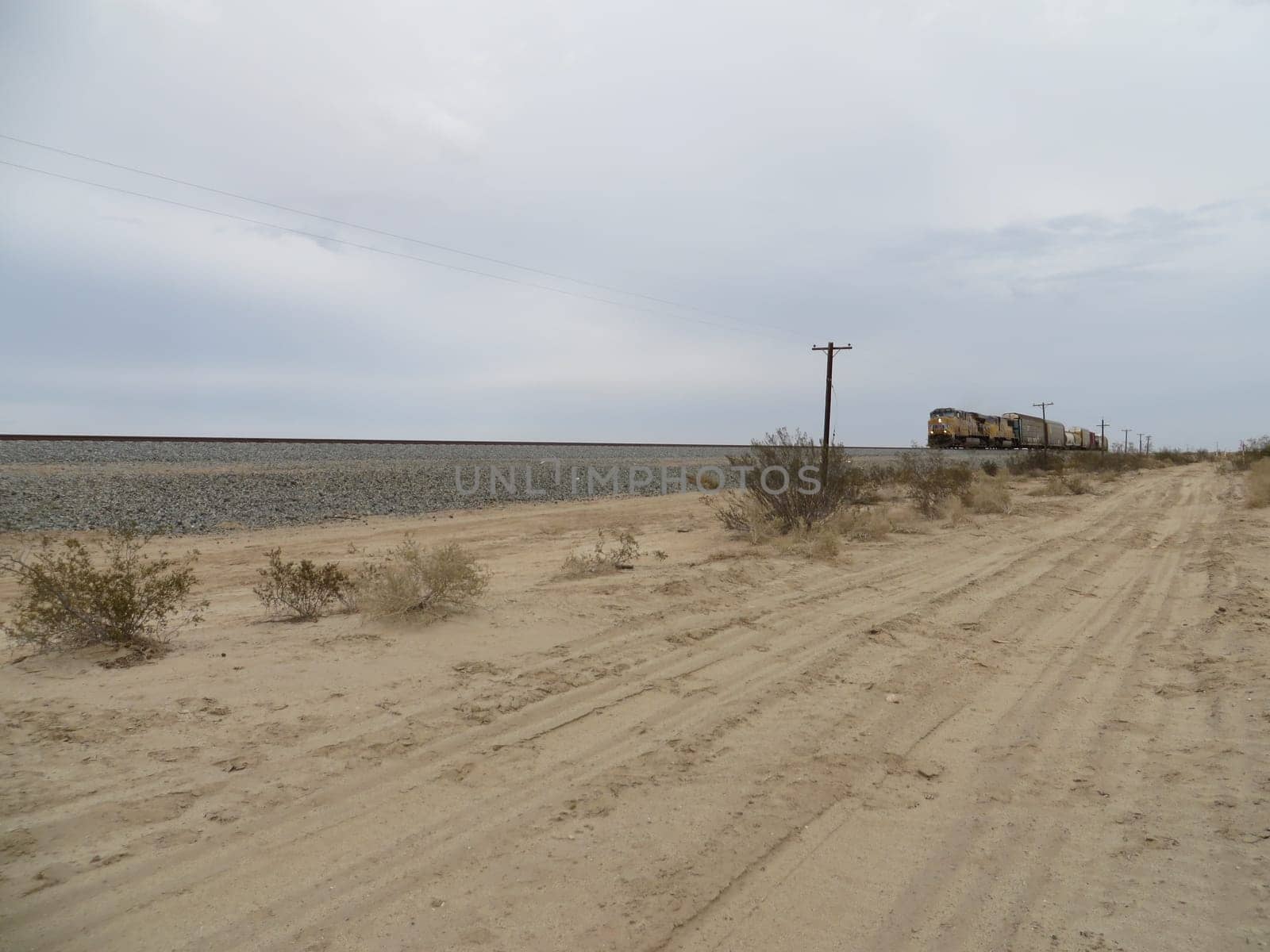 Far Away Freight Train Coming through the California Desert . High quality photo