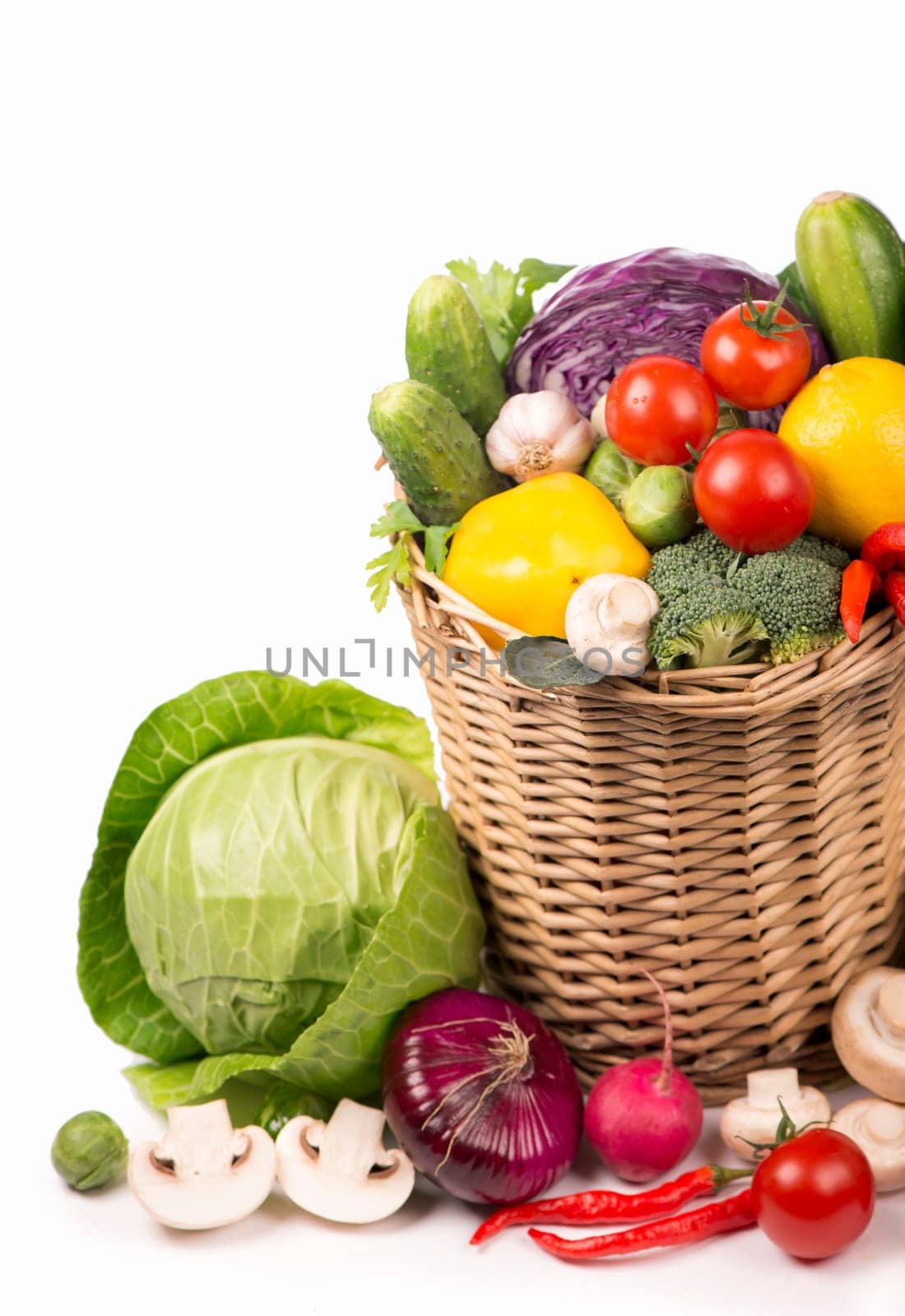 Top view of vegetables on wooden table and wicker basket, carrots velery tomatoes cabbage broccoli, copy space isolated on white background by aprilphoto