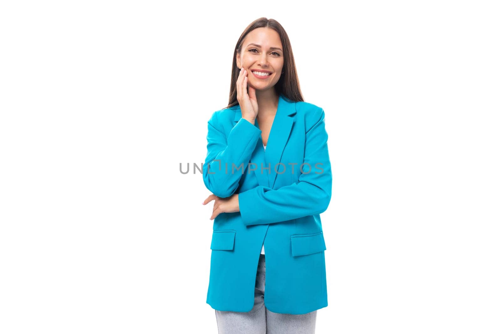 young well-groomed office worker woman with black straight hair in a blue business jacket on a white background with copy space.