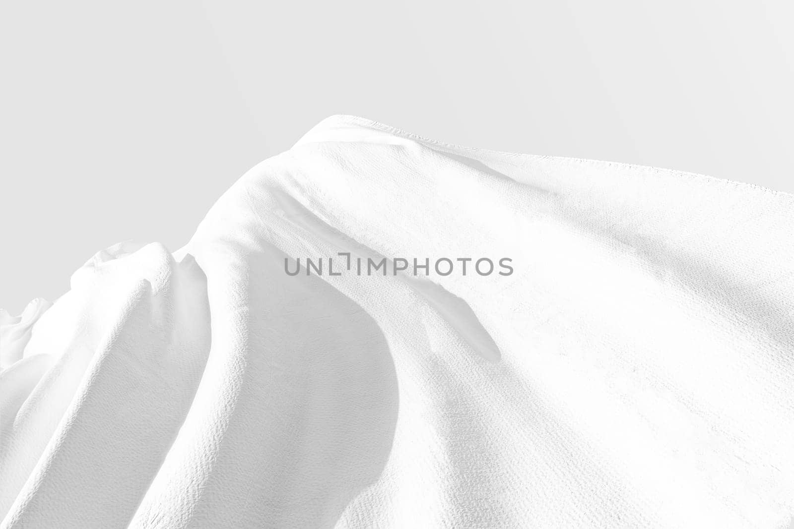 Background texture of crumpled white fabric on a light background with space for text