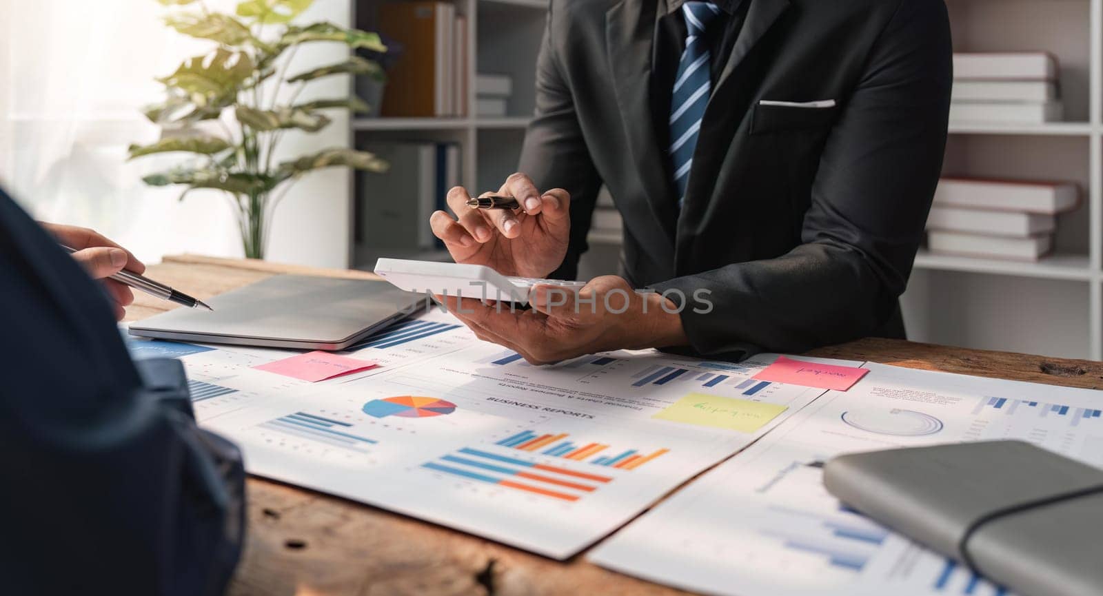 Businessman team analyzing financial statement finance task with calculator. Wealth management concept.