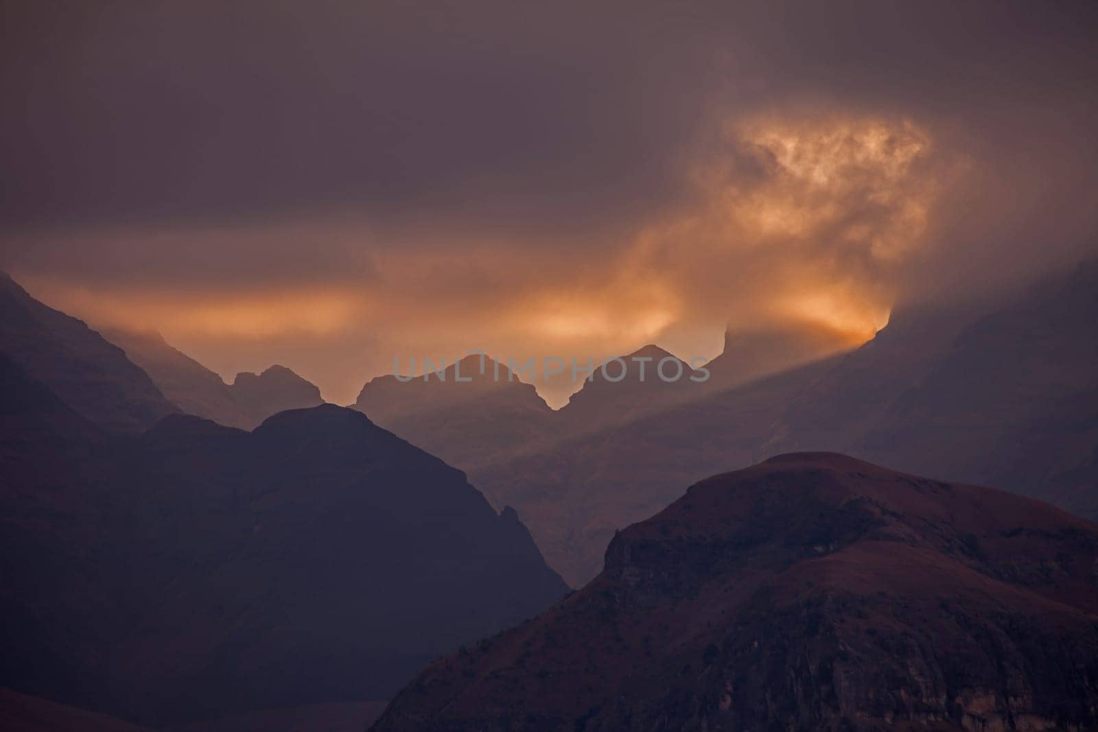 A stormy sunset at Cathedral Peak in the Drakensberg Mountains. KwaZulu-Natal Province, South Africa