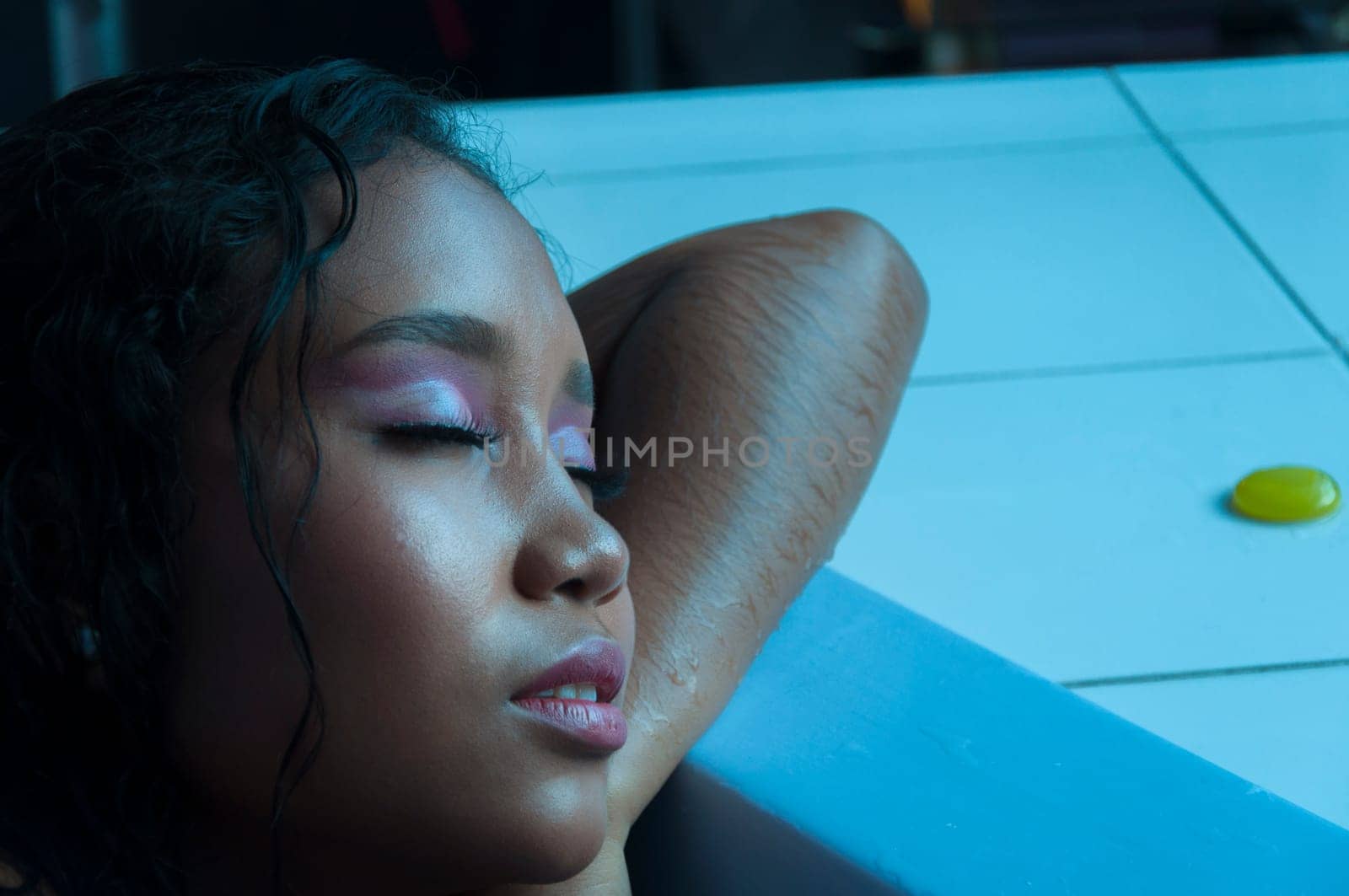 closeup with copyspace of a young latin woman with eyes closed in a moment of relaxation inside a jacuzzi. High quality photo