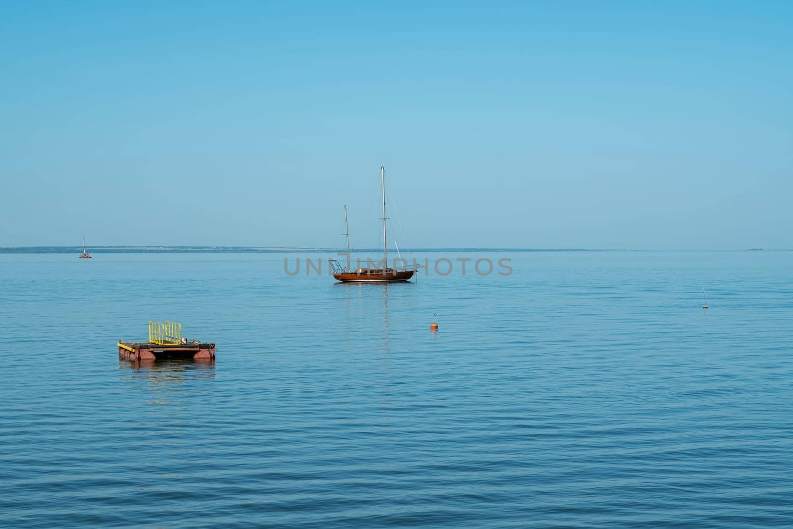 yachts on the water against the blue sky by roman112007