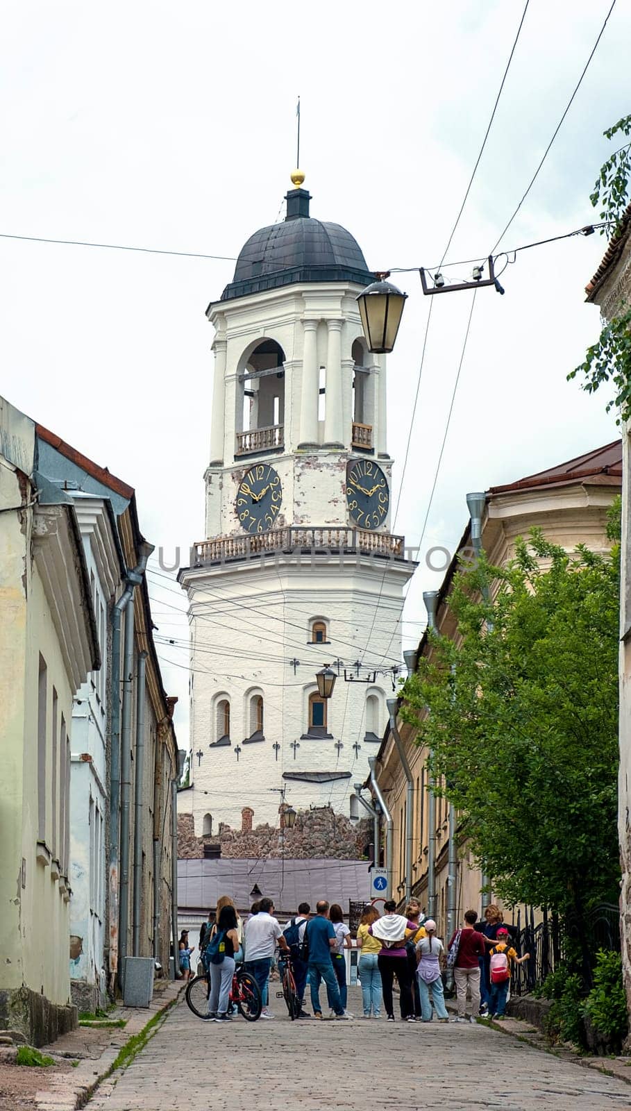 Vyborg, Leningrad region, Russia, 07.01.2023. View of the medieval Clock Tower from the old city street. Selective focus.