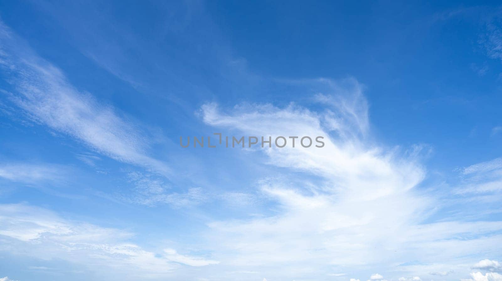 Blue sky and white cirrocumulus clouds texture background. Blue sky on sunny day. Summer sky. Cloud formation. Fluffy clouds. Nice weather in summer season. Weather pattern. Atmospheric phenomenon. by Fahroni