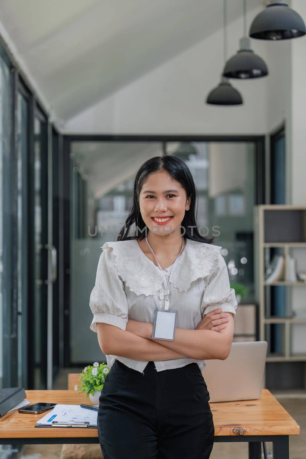 beautiful business asia woman stand in office, looking at the camera and smiling.