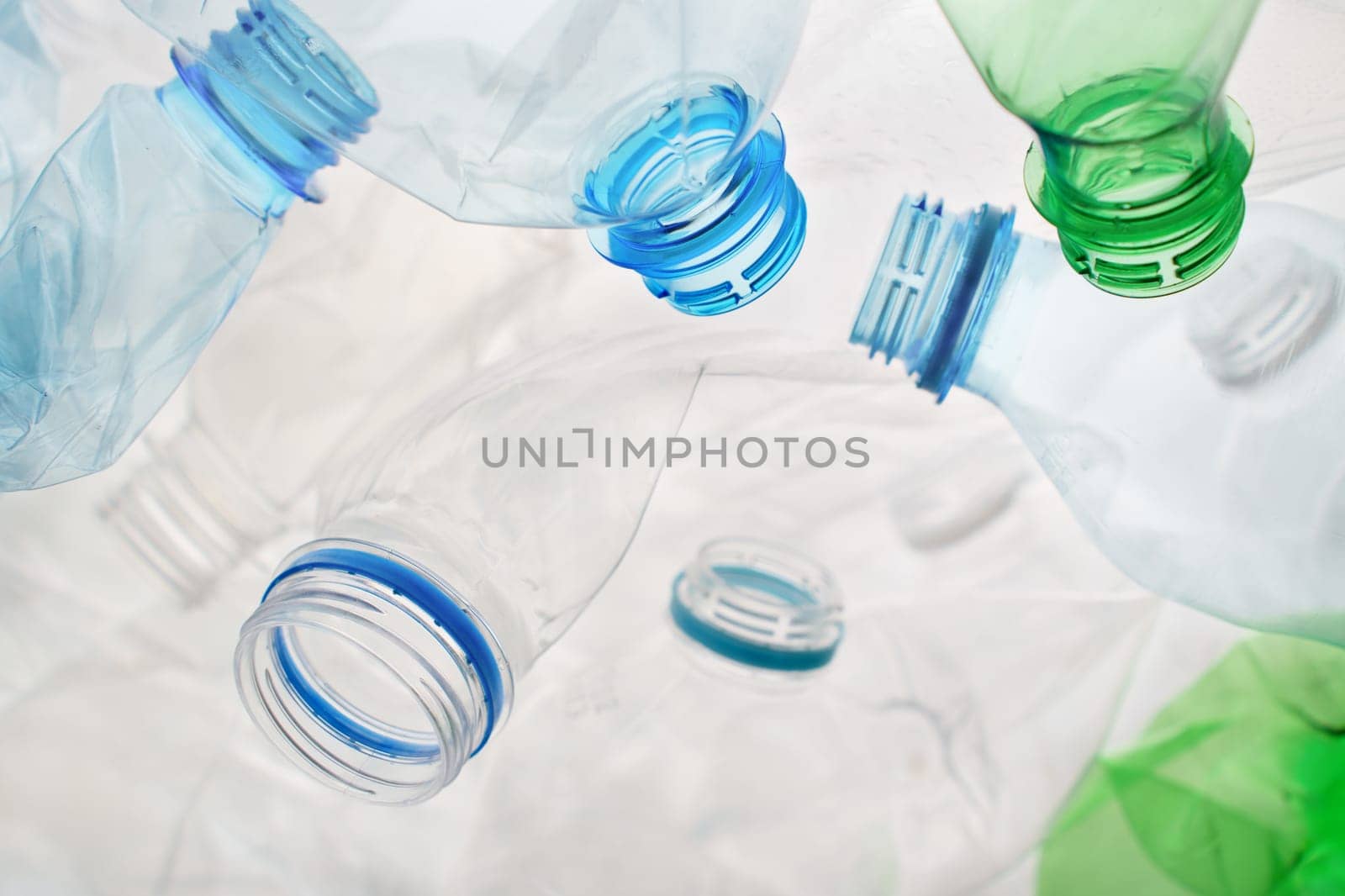 Transparent plastic bottle crumpled plastic recycling waste sorting. Pile of bottles PET recycling bottles background. Crushed bottle smashed plastic background. Recyclable materials. Disposable. Used by synel