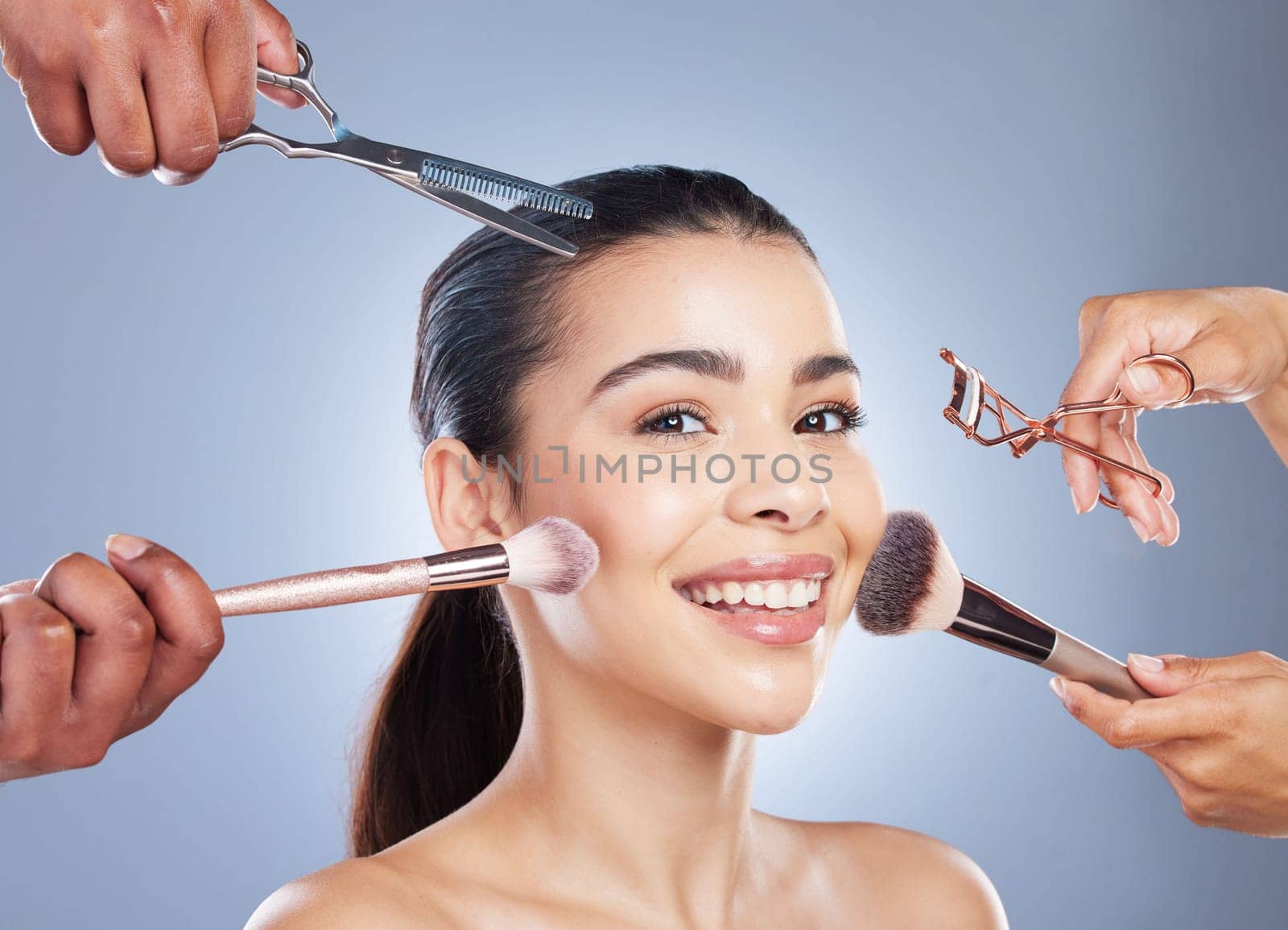 Hands with brush, makeup and portrait of woman in studio for wellness, beauty and cosmetics on blue background. Cosmetology, salon and face of girl for cosmetic application, foundation and products.