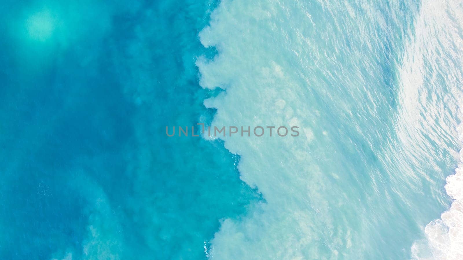 Top view of light blue water with white sand by Passcal