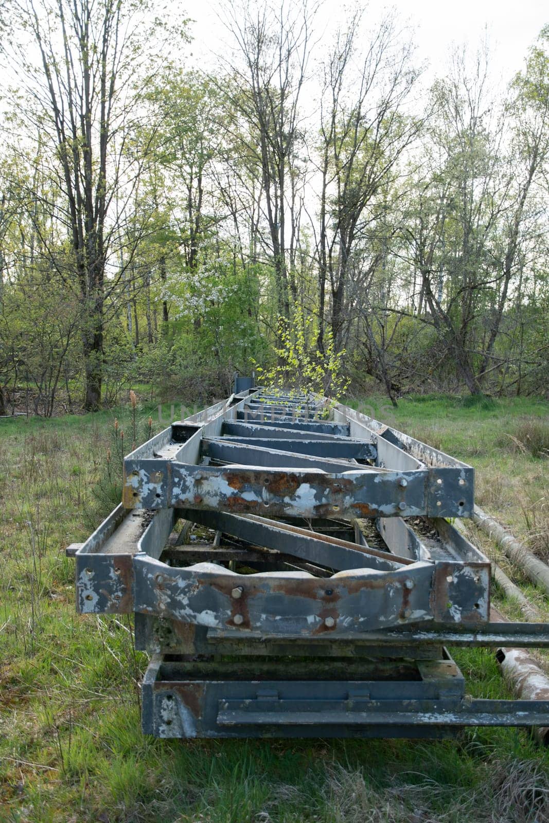 abandoned large metal structures with peeling paint in the middle of the forest by KaterinaDalemans