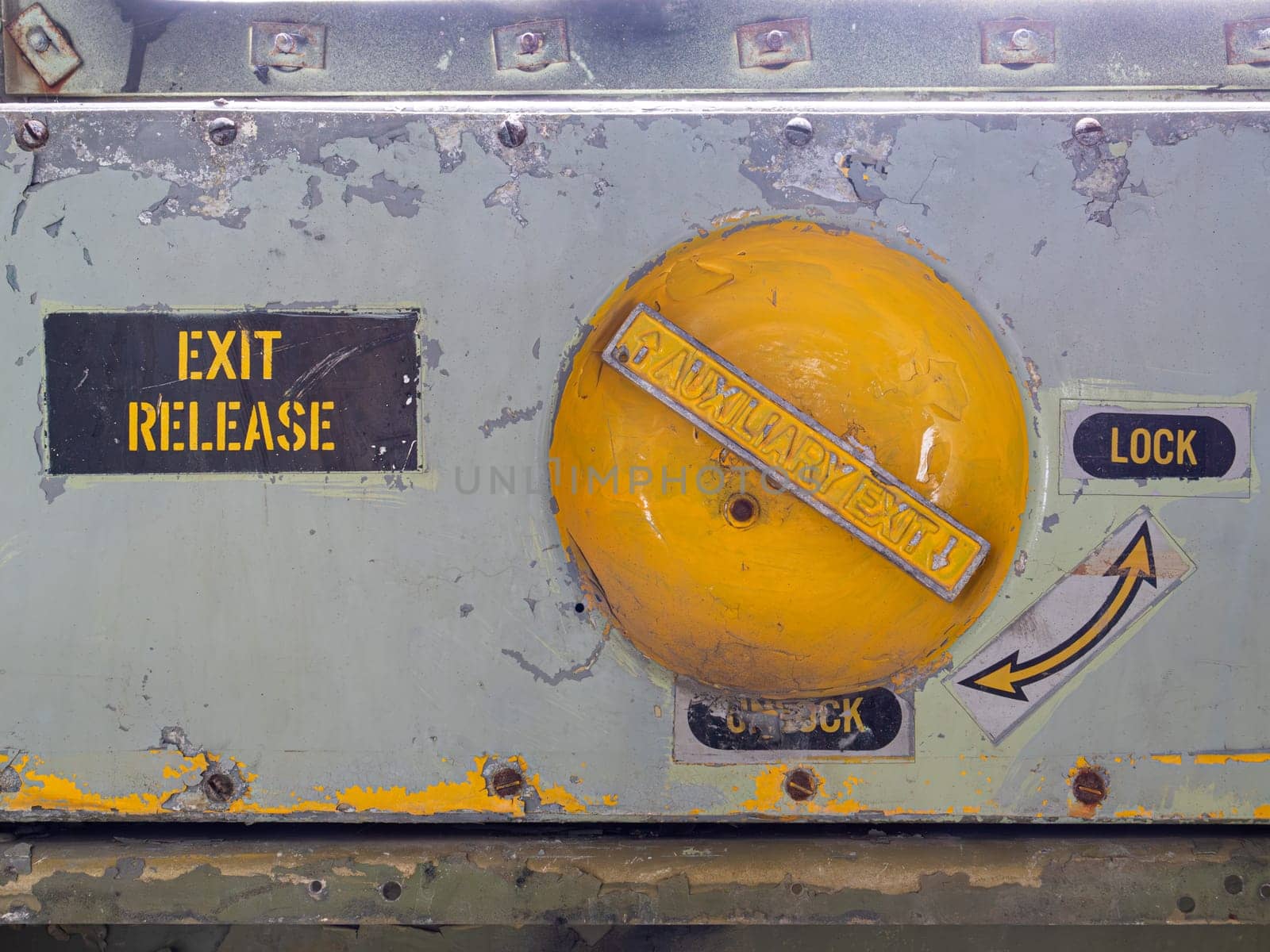 Image of old and rusty emergency exit release lock airplane mechanism