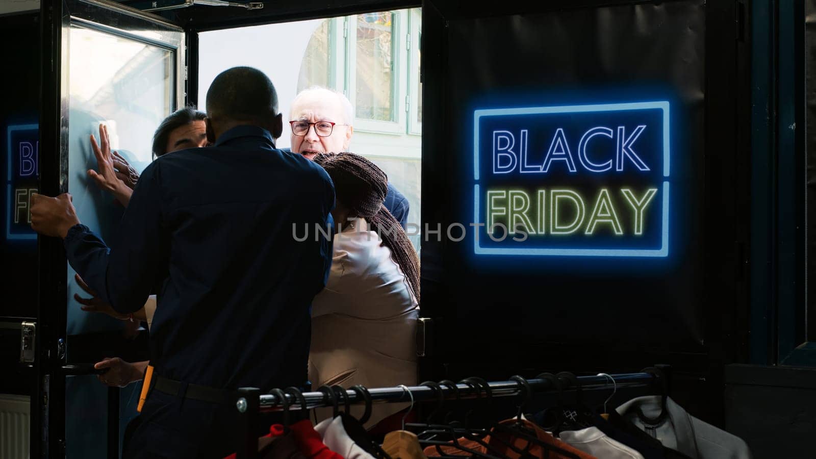 Diverse people demanding store access on black friday, trying to get inside of fashion boutique before opening hours. Anxious mad crowd fighting and arguing with security guard at entrance.