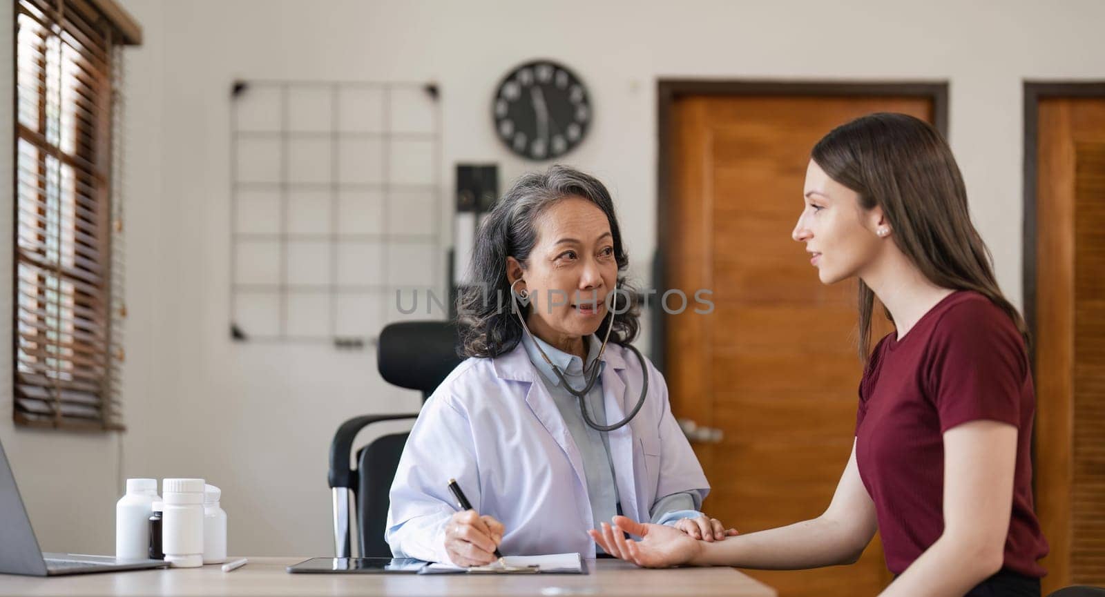 Consulting, doctor with woman in office for medical, checklist and results. Interview, healthcare and medicine with patient and expert in hospital for exam, help or advice.