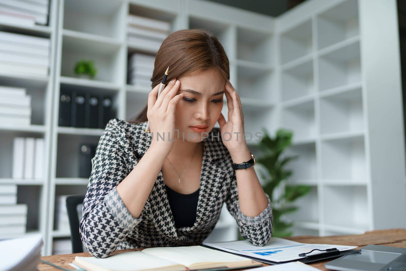 Portrait of business owner, woman using computer and financial statements Anxious expression on expanding the market to increase the ability to invest in business by Manastrong