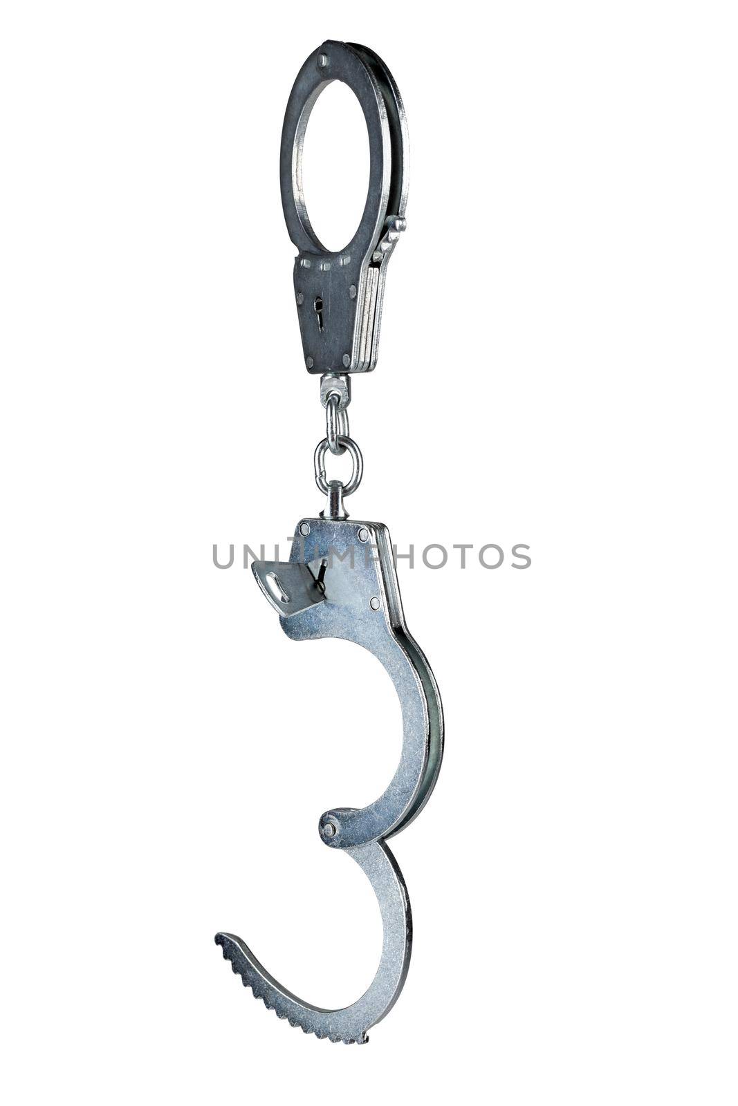 real zinc plated steel police handcuffs half-opened with key hanging vertically, isolated on white background.