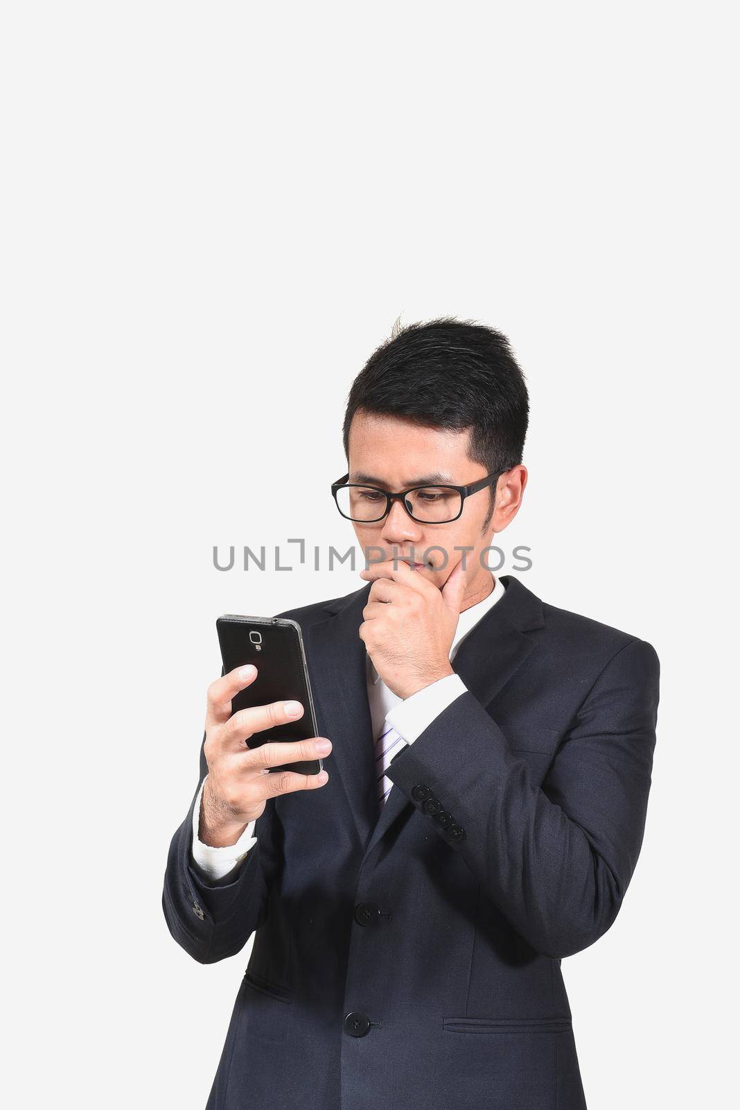 businessman checking emails on the phone by Wmpix