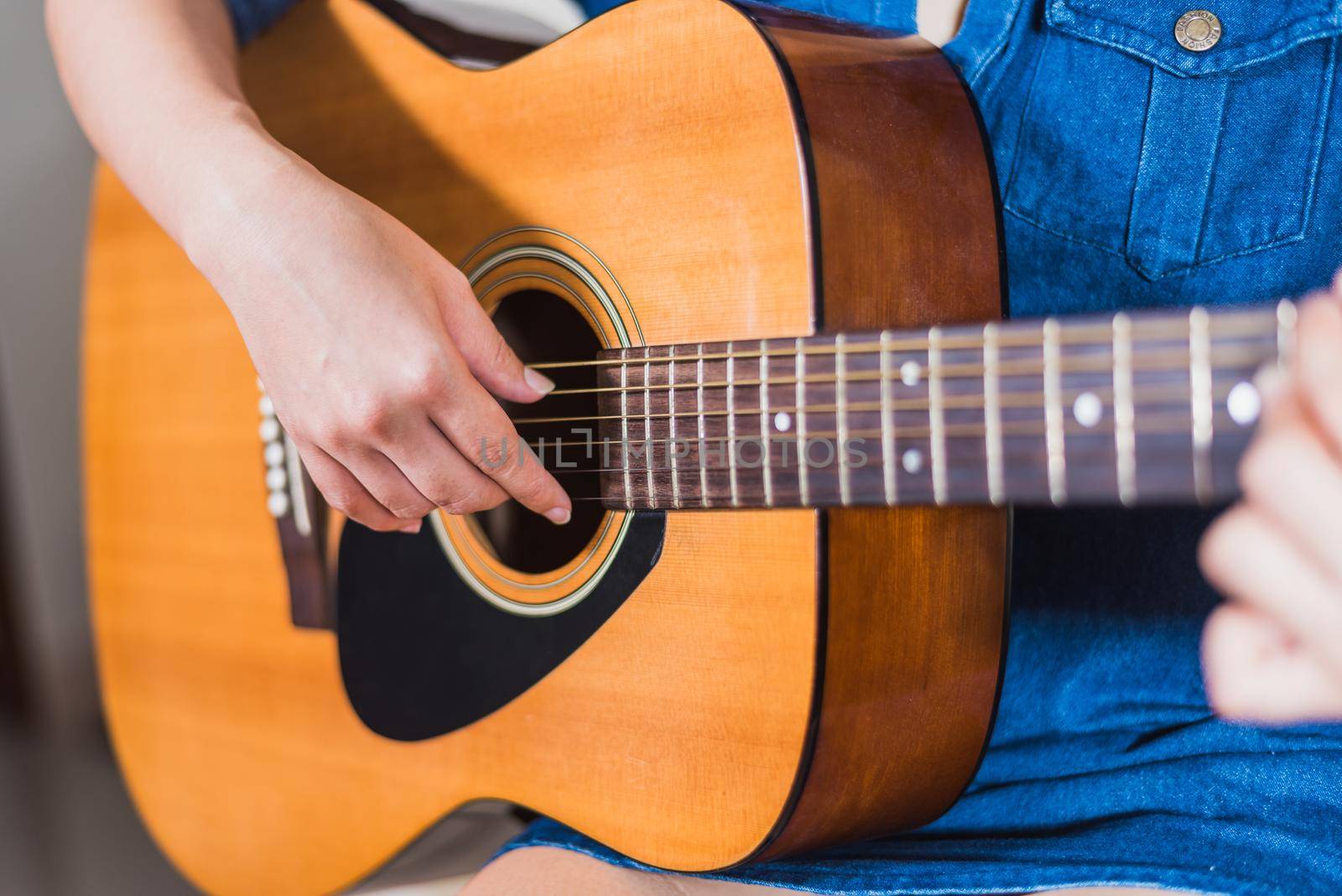 girl playing acoustic guitar isolate on white