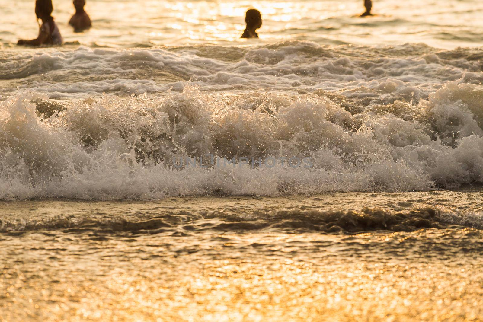 silhouette people wave sea beach sunset