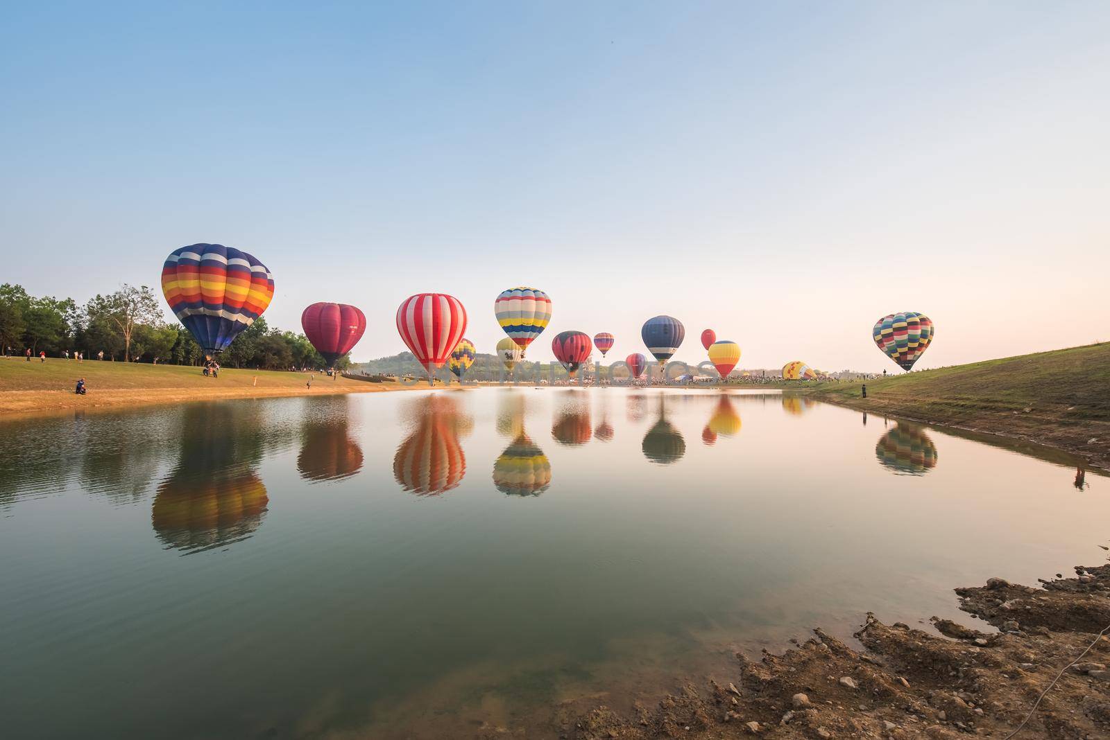 Hot air balloons floating over river