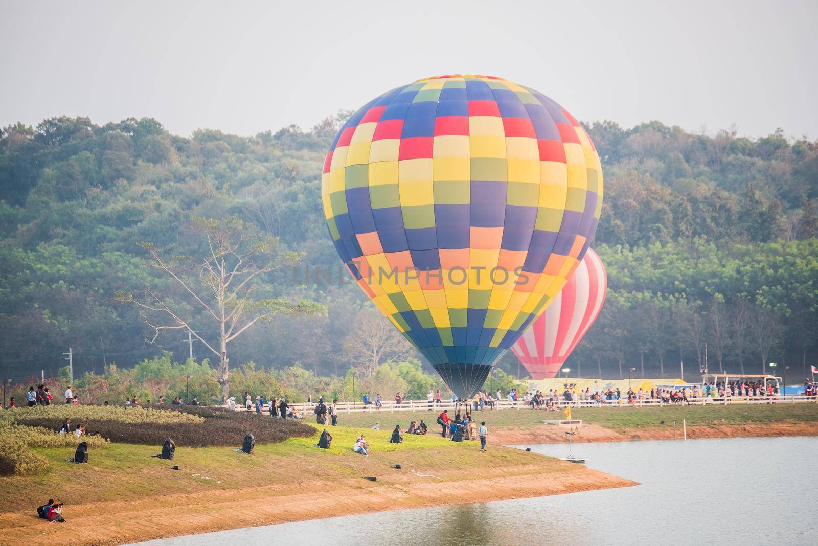 Hot air balloons floating over river by Wmpix