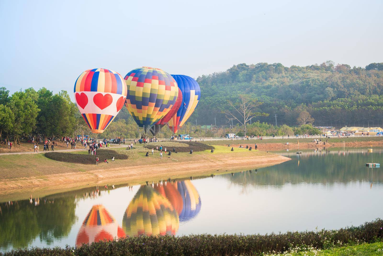 Hot air balloons floating over river