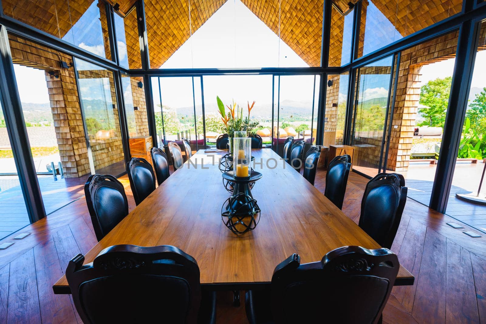 classic dining room wood table at resort by Wmpix